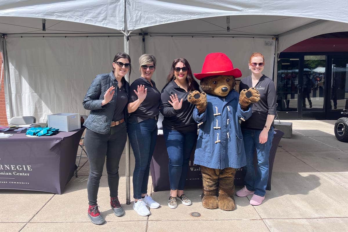 The Carnegie sales team posing at the Book Festival with Paddington Bear.
